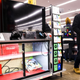 A customer olds a plastic bag as he walks by the cabinet.
